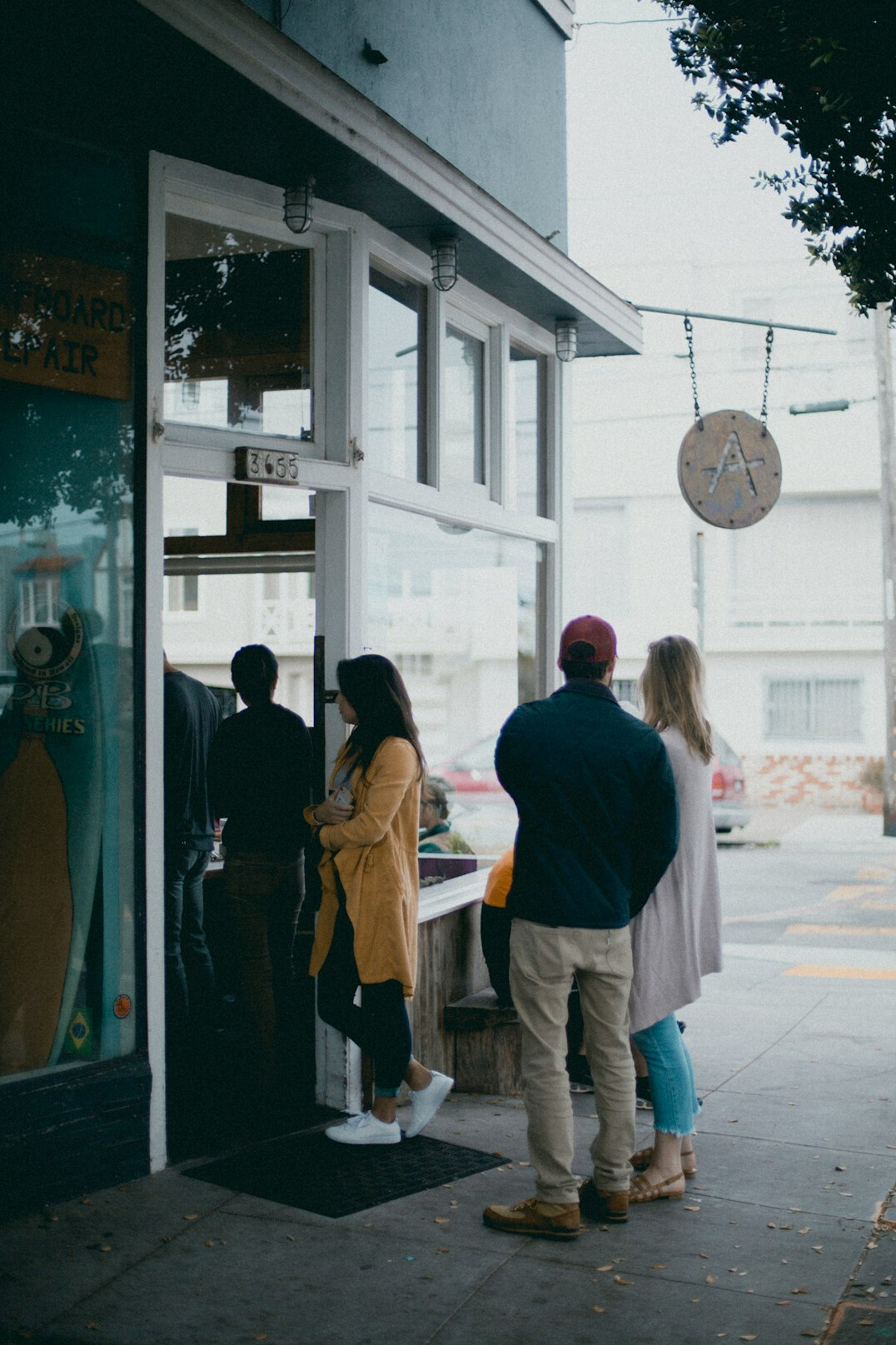 Customers queuing outside a small bakery in the morning