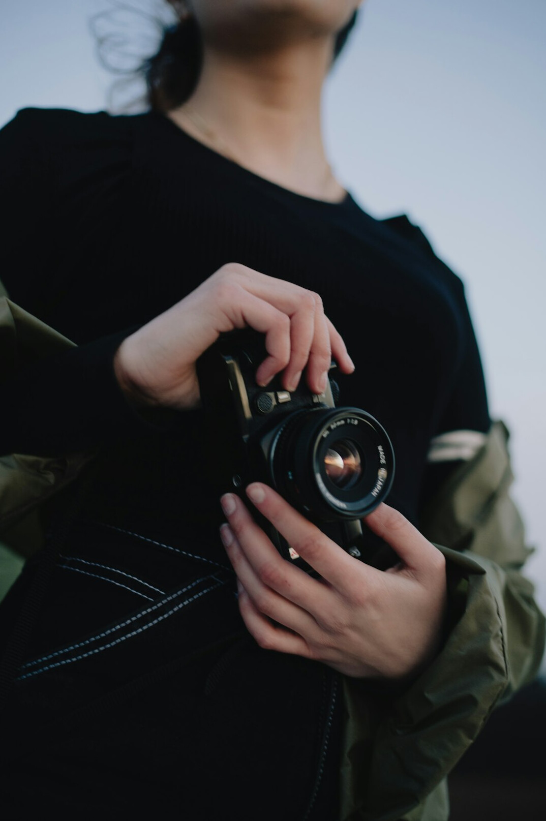 Portrait of a female photojournalist holding a camera